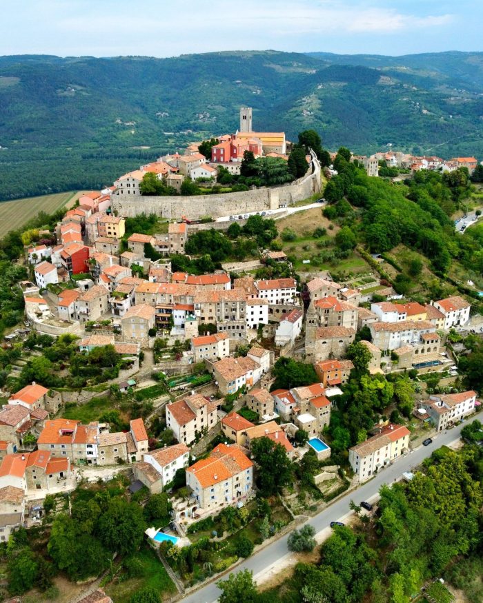 Aerial view of Motovun town on a hilltop with residential buildings in Croatia