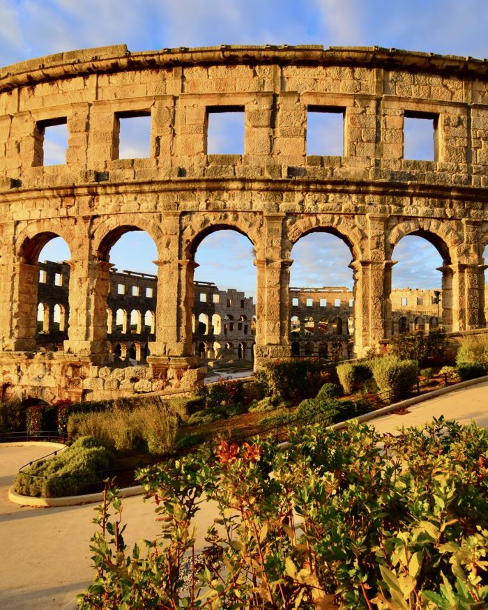 Pula Arena, a historical building bathed in golden hour light in Istria, Croatia.