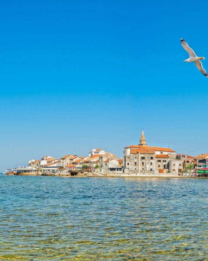 View of the coast and the promontory of Umag with the old town in Istria, Croatia.